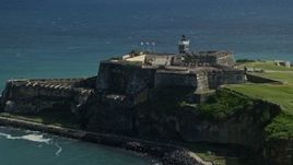 4.8K aerial stock footage of a Historic fort along the coast resting on clear blue water, Old San Juan Puerto Rico Aerial Stock Footage | AX101_016E