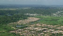 4.8K aerial stock footage of Residential neighborhoods among trees and grassy areas, Dorado, Puerto Rico Aerial Stock Footage | AX101_033E