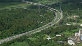4.8K aerial stock footage of a Highway cutting through rural area of grass and trees, Vega Alta, Puerto Rico Day  Aerial Stock Footage | AX101_036