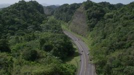 4.8K aerial stock footage of a Highway through lush green mountains, Karst Forest, Puerto Rico Aerial Stock Footage | AX101_080