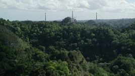 4.8K aerial stock footage of Arecibo Observatory seen from lush green mountains, Puerto Rico Aerial Stock Footage | AX101_108E