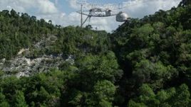 4.8K aerial stock footage Low approach above trees toward Arecibo Observatory, Puerto Rico Aerial Stock Footage | AX101_115E