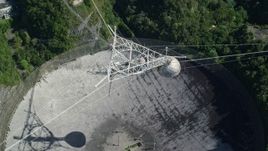 4.8K aerial stock footage Ascending above Arecibo Observatory surrounded by trees, Puerto Rico Aerial Stock Footage | AX101_117E