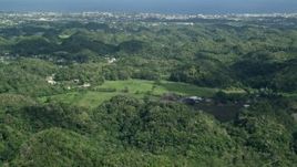 4.8K aerial stock footage Flying over tree covered hills toward the coast, Arecibo, Puerto Rico Aerial Stock Footage | AX101_128E
