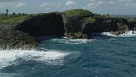 4.8K aerial stock footage of Rock formations along the coast of clear blue water, Arecibo, Puerto Rico  Aerial Stock Footage | AX101_162