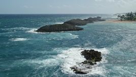 4.8K aerial stock footage of rock formations in pristine blue waters, Vega Baja, Puerto Rico Aerial Stock Footage | AX101_201E