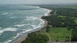 4.8K aerial stock footage following the beach over a lagoon on the coast, Dorado, Puerto Rico Aerial Stock Footage | AX101_220E