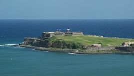 4.8K aerial stock footage of Fort San Felipe del Morro surrounded by crystal blue waters, Old San Juan Puerto Rico Aerial Stock Footage | AX101_235E