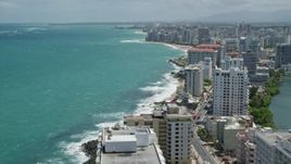 4.8K aerial stock footage of flying over and by hotels and high rises on the coast and crystal blue water, San Juan, Puerto Rico Aerial Stock Footage | AX102_002E