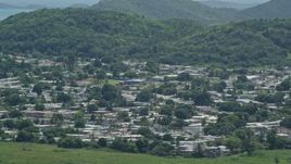 4.8K aerial stock footage of homes among tree covered hills, Fajardo, Puerto Rico Aerial Stock Footage | AX102_055E