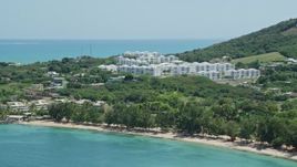 4.8K aerial stock footage of The Ocean Club at Seven Seas seen from the beach, Fajardo, Puerto Rico  Aerial Stock Footage | AX102_059