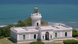 4.8K aerial stock footage of Cape San Juan Light looking out on to crystal blue waters, Puerto Rico Aerial Stock Footage | AX102_066