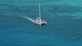 4.8K aerial stock footage Tracking a catamaran in crystal clear blue tropical waters, Rada Fajardo, Puerto Rico  Aerial Stock Footage | AX102_076