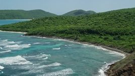 4.8K aerial stock footage of sapphire blue waters and green covered coastline, Culebra, Puerto Rico Aerial Stock Footage | AX102_110E