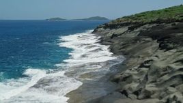 4.8K aerial stock footage of sapphire blue waters along a rugged coast, Culebra, Puerto Rico Aerial Stock Footage | AX102_126E