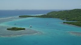 4.8K aerial stock footage of a Fishing boat and sailboats in turquoise blue waters along the coast, Culebra, Puerto Rico  Aerial Stock Footage | AX102_136