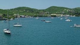 4.8K aerial stock footage of sailboats in sapphire blue waters near small town on the coast, Culebra, Puerto Rico Aerial Stock Footage | AX102_160E