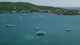 4.8K aerial stock footage of Sailboats in blue waters along the coast, Culebra, Puerto Rico Aerial Stock Footage | AX102_167