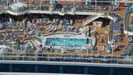 4.8K aerial stock footage of a Populated pool area on a cruise ship, Charlotte Amalie, St. Thomas Aerial Stock Footage | AX102_204