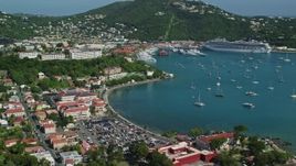 4.8K aerial stock footage of Sailboats and cruise ship in sapphire blue waters along a coastal town, Charlotte Amalie, St Thomas Day Sunny Side View Aerial Stock Footage | AX102_224
