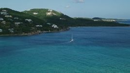 4.8K aerial stock footage of a Sailboat in sapphire blue waters along oceanfront homes, Southside, St Thomas Aerial Stock Footage | AX102_234
