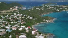 4.8K aerial stock footage Flying over trees and homes surrounded by sapphire blue waters, Red Hook, St Thomas Aerial Stock Footage | AX102_240