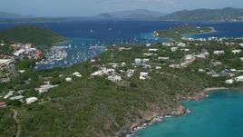 4.8K aerial stock footage Flying over homes toward Caribbean blue waters, Red Hook, St Thomas Aerial Stock Footage | AX102_241