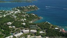 4.8K aerial stock footage of Secret Harbor Beach Resort and oceanfront mansions by turquoise Caribbean waters, St Thomas, US Virgin Islands Aerial Stock Footage | AX102_245E