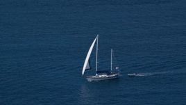 4.8K aerial stock footage of a Sailboat in sapphire blue waters, St Thomas, USVI Aerial Stock Footage | AX102_255