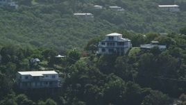 4.8K aerial stock footage of a Hilltop home surrounded by trees, East End, St Thomas Aerial Stock Footage | AX102_261
