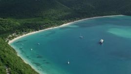 4.8K aerial stock footage of White sand Caribbean beach surrounded by trees and turquoise blue waters, Magens Bay, St Thomas  Aerial Stock Footage | AX102_284