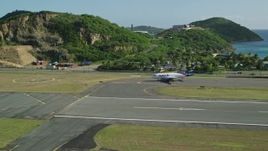 4.8K aerial stock footage of a jet at Cyril E King Airport along Caribbean blue waters, St Thomas Aerial Stock Footage | AX103_001