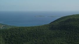 4.8K aerial stock footage of tree-covered hills above blue Caribbean waters, Southside, St Thomas Aerial Stock Footage | AX103_009E