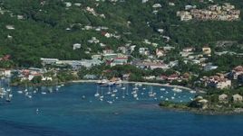 4.8K aerial stock footage of a coastal town and hillside homes along Caribbean blue waters, Cruz Bay, St John Aerial Stock Footage | AX103_017E