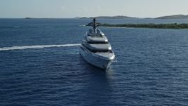 4.8K aerial stock footage of a yacht in sun-kissed Caribbean waters among small islands, Cruz Bay, St John Aerial Stock Footage | AX103_025E