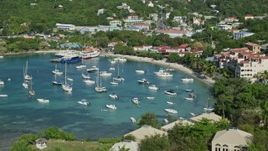 4.8K aerial stock footage of the blue Caribbean waters in the harbor and hillside homes, Cruz Bay, St John Aerial Stock Footage | AX103_029E