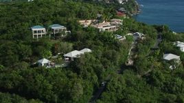 4.8K aerial stock footage of ocean view homes on a green hillside, Cruz Bay, St John Aerial Stock Footage | AX103_032E
