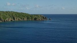 4.8K aerial stock footage of a Tree covered rugged coast along blue waters of Great Lameshur Bay, St John Aerial Stock Footage | AX103_056