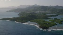 4.8K aerial stock footage of Tiny islands in sapphire blue Caribbean waters along the shores, East End, St Thomas Aerial Stock Footage | AX103_065