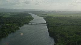 4.8K aerial stock footage of Caribbean beach and small bridge over a river, Loiza, Puerto Rico Aerial Stock Footage | AX103_135E