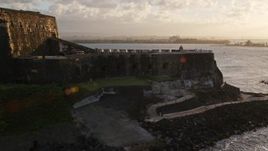 4.8K aerial stock footage of Fort San Felipe del Morro and blue ocean waters, Old San Juan, sunset Aerial Stock Footage | AX104_029