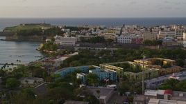 4.8K aerial stock footage of La Fortaleza among Caribbean buildings, Old San Juan, sunset Aerial Stock Footage | AX104_034E
