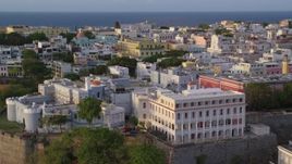 4.8K aerial stock footage of La Fortaleza among neighboring buildings, Old San Juan, sunset Aerial Stock Footage | AX104_038