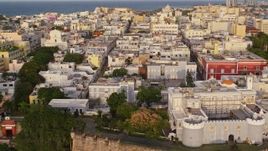 4.8K aerial stock footage of La Fortaleza and neighboring buildings, Old San Juan, Puerto Rico, sunset Aerial Stock Footage | AX104_039E