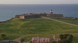 4.8K aerial stock footage of Fort San Felipe del Morro overlooking the ocean, Old San Juan sunset Aerial Stock Footage | AX104_042