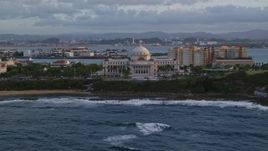 4.8K aerial stock footage of San Juan Capitol Building along the coast, Old San Juan, Puerto Rico, sunset Aerial Stock Footage | AX104_050
