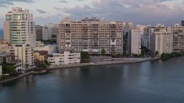 4.8K aerial stock footage of Hotels along Caribbean blue waters, San Juan, Puerto Rico sunset Aerial Stock Footage | AX104_061