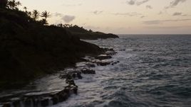 4.8K aerial stock footage fly low over the ocean along Caribbean coastline, Dorado, Puerto Rico, twilight Aerial Stock Footage | AX104_116E