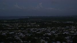 4.8K aerial stock footage ascend from the coast to reveal Caribbean town, Dorado, Puerto Rico, sunset Aerial Stock Footage | AX104_135E