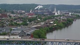 4.8K aerial stock footage ascend over bridge and reveal a U.S. Steel Mon Valley Works, Braddock, Pennsylvania Aerial Stock Footage | AX105_044E